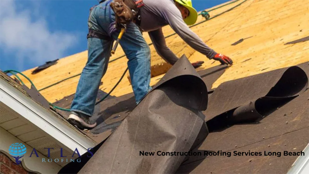Roofer installing underlayment for new construction roof in Long Beach